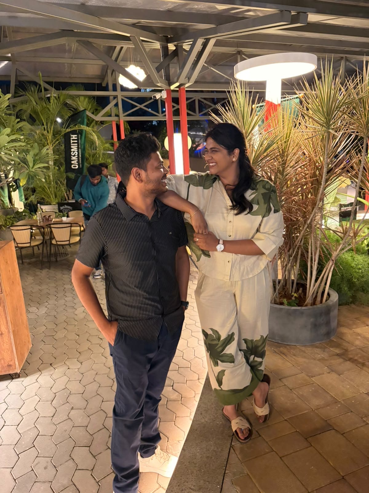 Ayush and Rajavi smiling together at a café